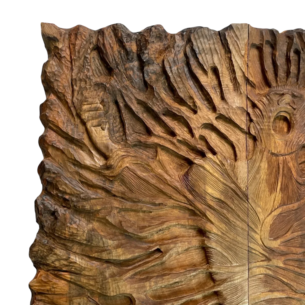 Close-up of the deep carving on the backgammon exterior, with an open-mouthed face on the right