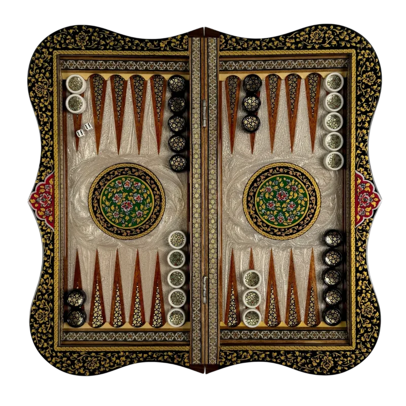Open wavy-edged backgammon from above; mother-of-pearl playing surface, green floral tazhib medallions in the center, checkers and dice